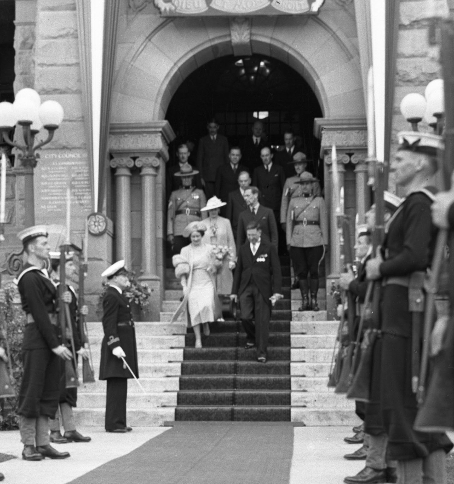 Queen Elizabeth (The Queen Mother) is escorted down the steps of Historic City Hall by Calgary Mayor Andrew Davison