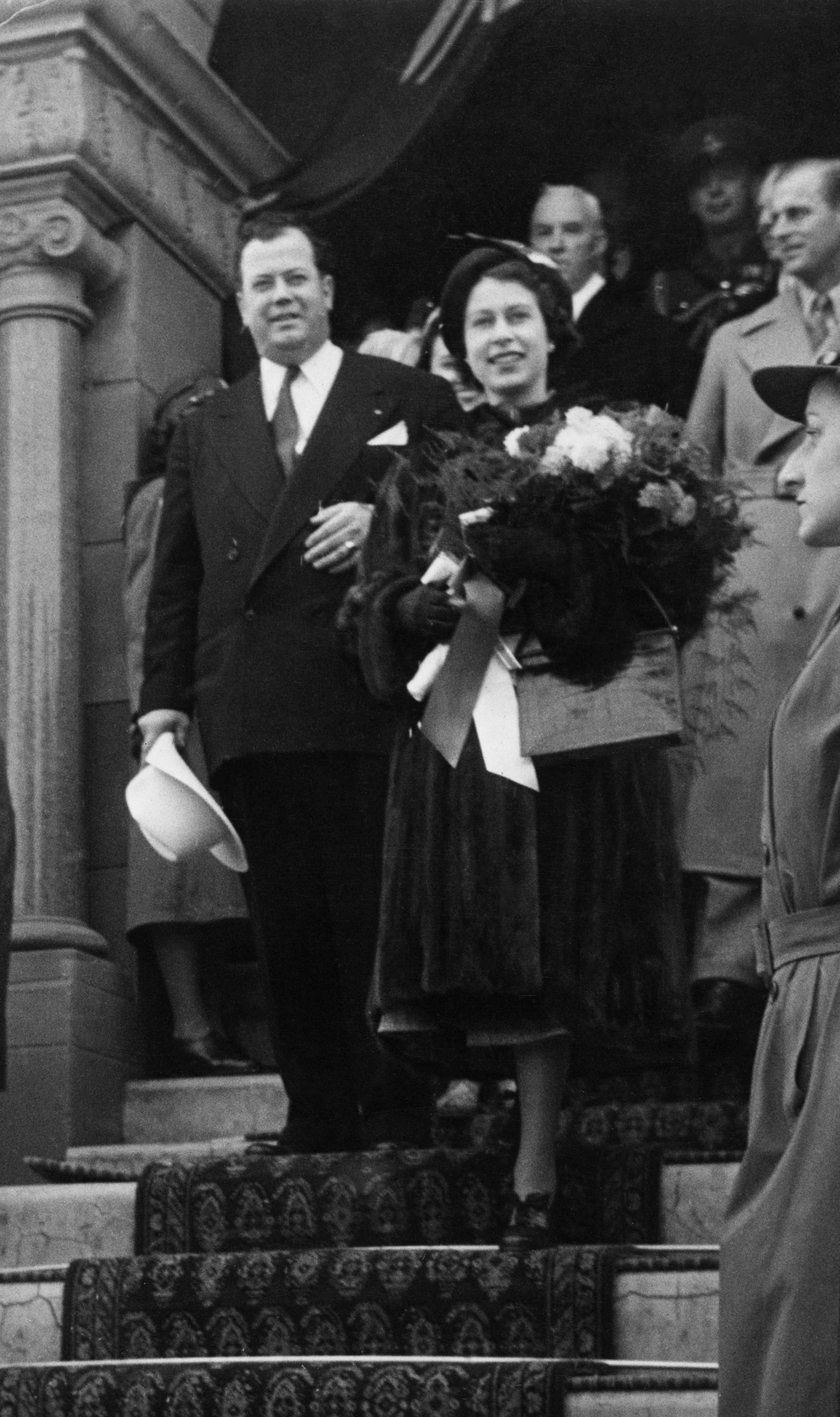 Princess Elizabeth (now Queen Elizabeth) is escorted down the steps of City Hall by Calgary Mayor Don Mackay. 