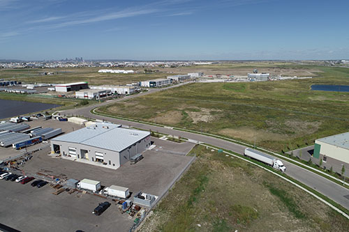 Aerial view of warehouse, road, industrial land, and 