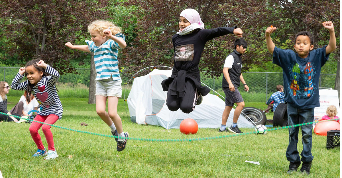 Children jumping over a rope as part of a City summer activity