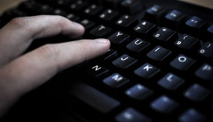 An individual typing on a keyboard.