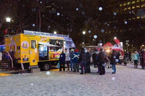 People gathered around a food truck in the winter