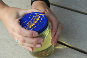 Safely putting the lid on a jar with motor oil.