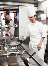 Chef cooking over stove